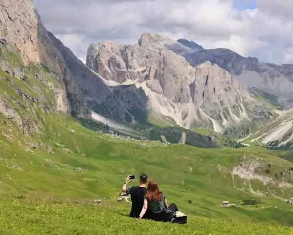 Para, która robi sobie selfie na tle Dolomitów. Idealne miejsce, gdzie warto pojechać na wakacje.